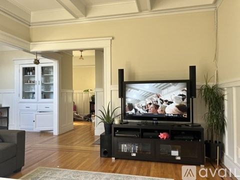 A living room with a television and a cabinet.