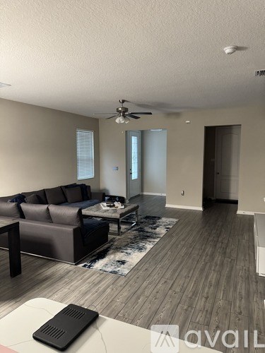 A living room with a couch, a coffee table, and a rug.