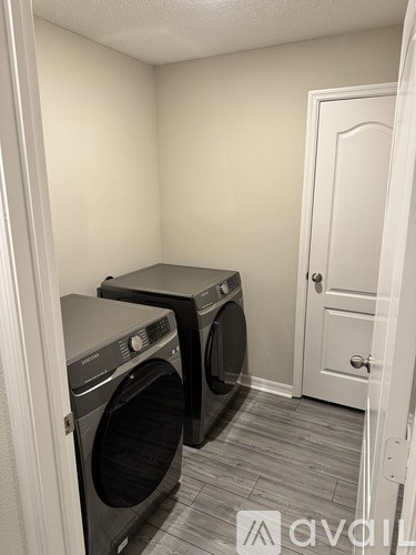 A small laundry room with two front-loading washing machines.