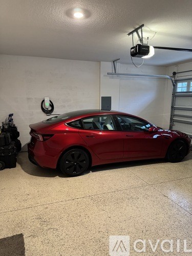 A red car is parked in a garage.