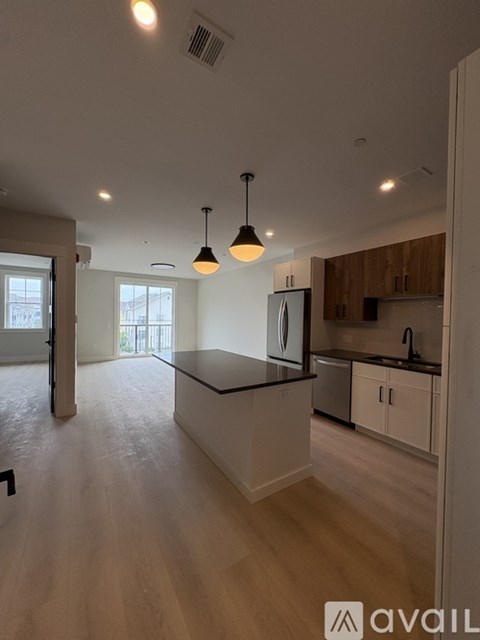 A kitchen with a black countertop and wooden cabinets.