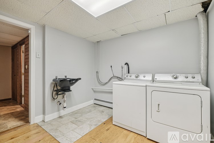 A white washing machine and dryer in a laundry room.