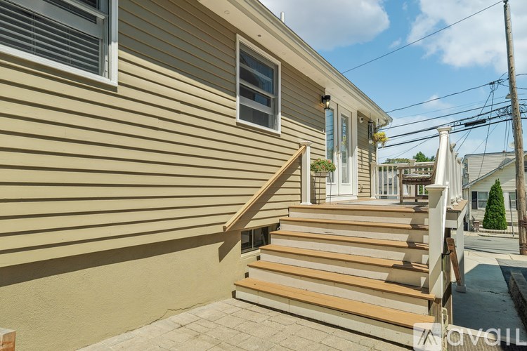 A house with a wooden staircase leading to the front door.