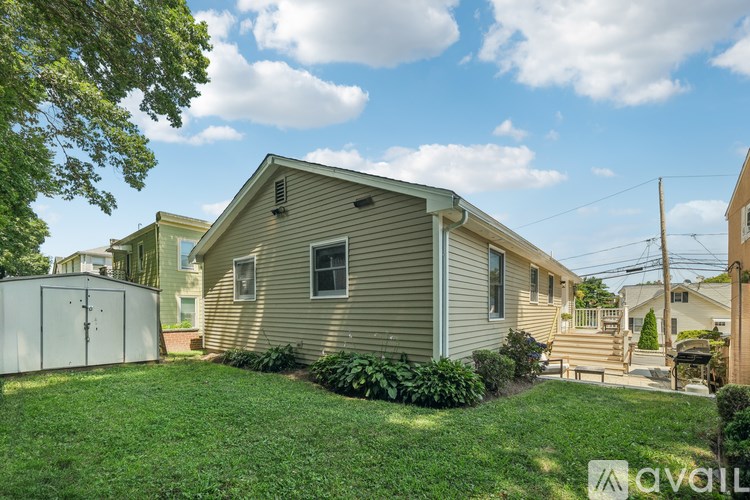 A house with a well-kept lawn and a clear sky above.