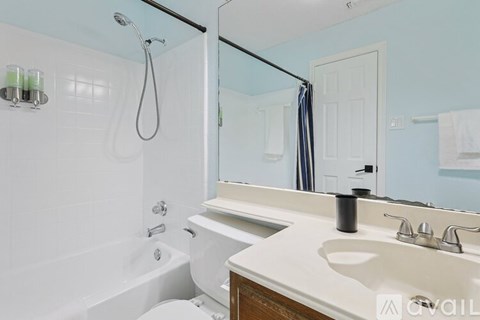 A white bathroom with a white tub and sink.