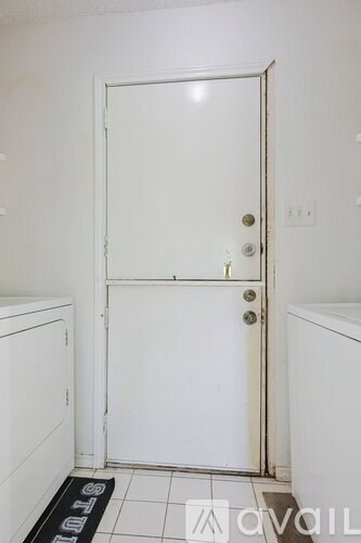 A white door with a silver handle and a doorknob.