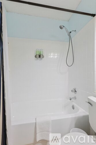 A white bathroom with a tub and shower.