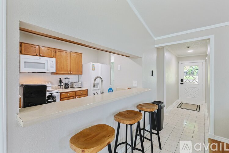 A kitchen with wooden cabinets and white appliances.