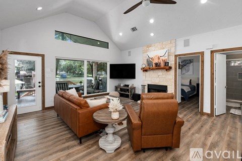 A living room with a brown leather chair and a white coffee table.