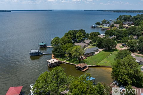 A bird's eye view of a residential area with houses, boats, and a dock.