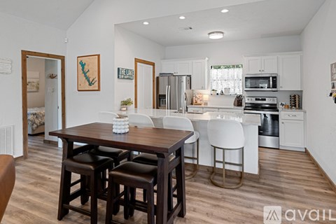 A kitchen with a table and chairs in the middle of the room.