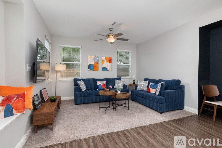 A living room with a blue couch and a wooden coffee table.