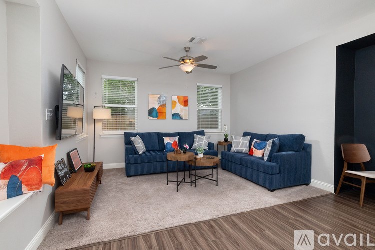 A living room with a blue couch and a wooden coffee table.