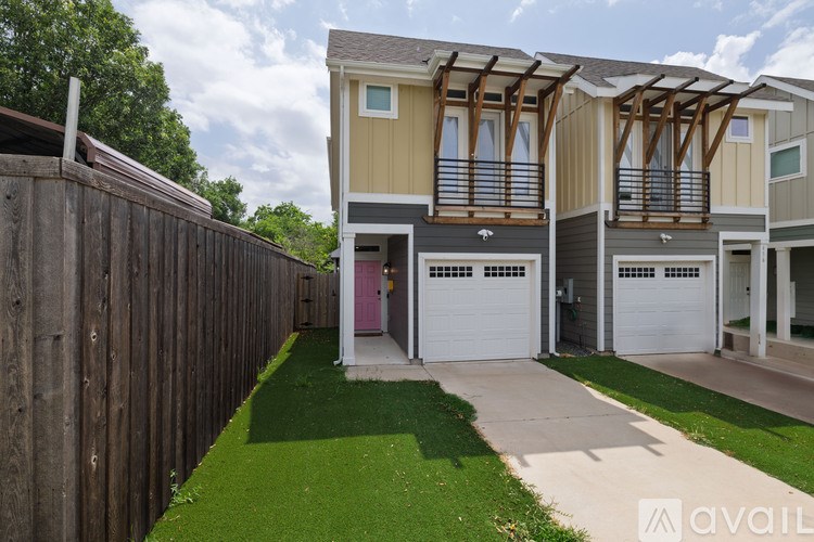 A row of houses with a green lawn in front.