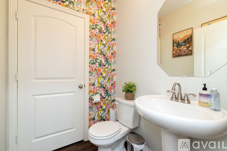 A white toilet sits next to a sink in a small bathroom.