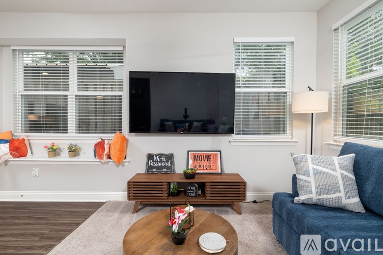 A living room with a wooden coffee table and a blue couch.