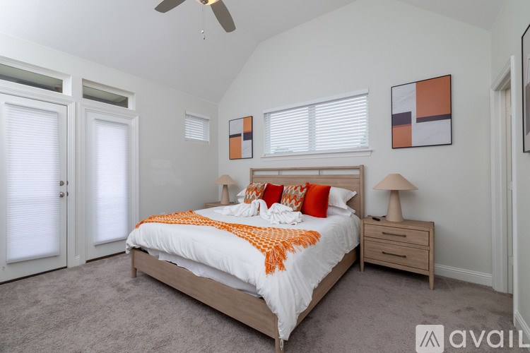 A bedroom with a bed, nightstand, and a ceiling fan.