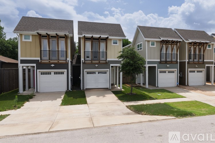 A row of houses with garages are available for sale.