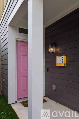 A pink door is on the left and a yellow box is on the right.