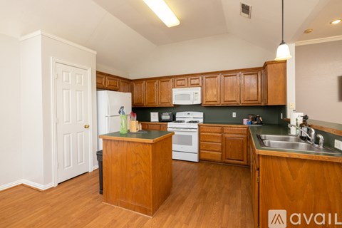 A kitchen with wooden cabinets and a white refrigerator.