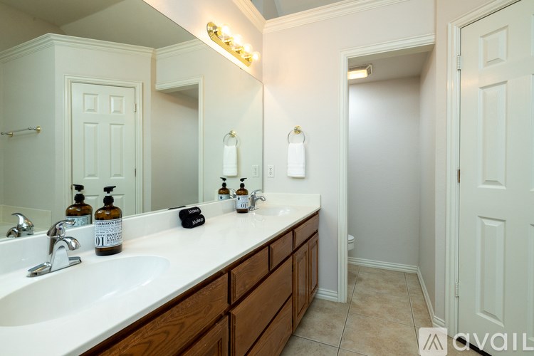 A bathroom with a white sink and a mirror above it.