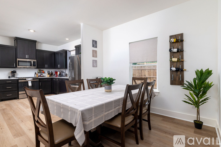 A dining room with a table set for four.