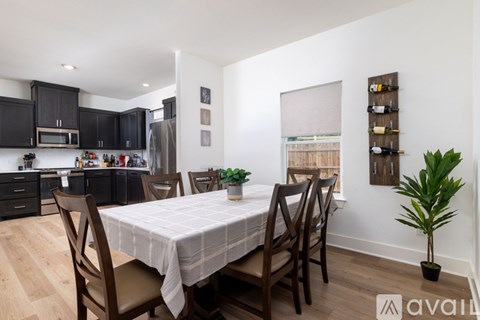 A dining room with a table set for four.