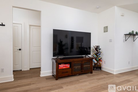A living room with a television and a cabinet.