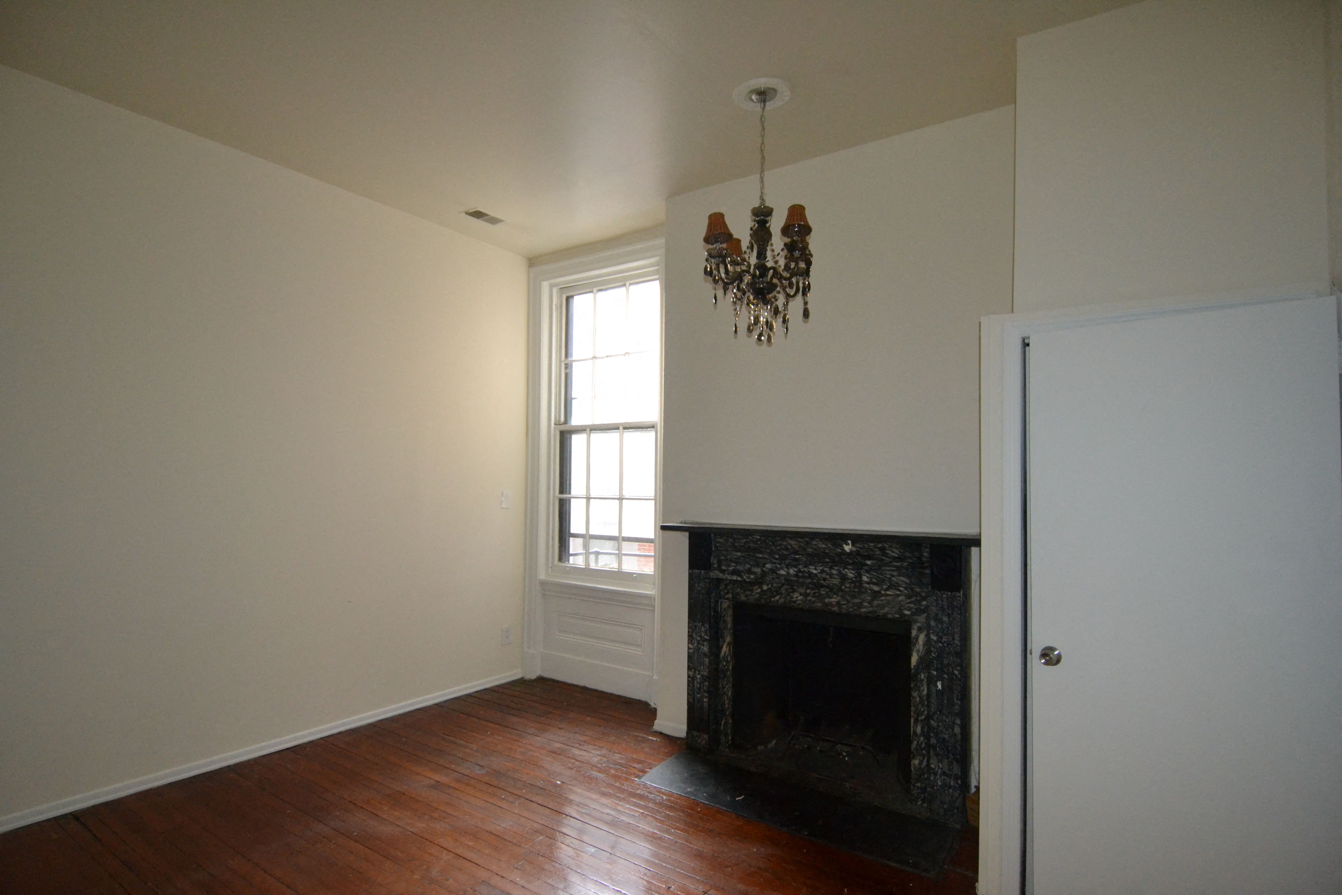 a living room with a fireplace and a window