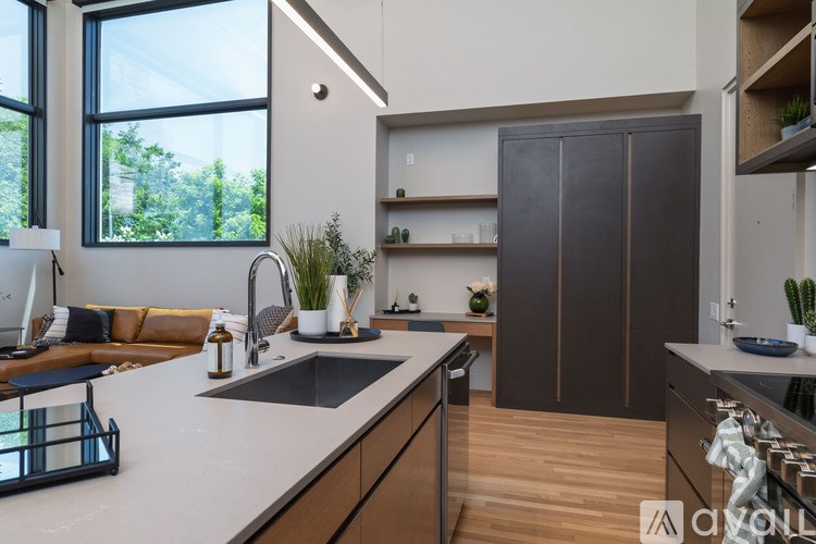 A modern kitchen with a dark brown cabinet and a white countertop.