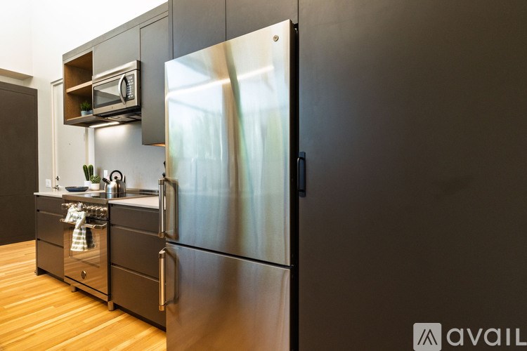 A modern kitchen with a stainless steel refrigerator.