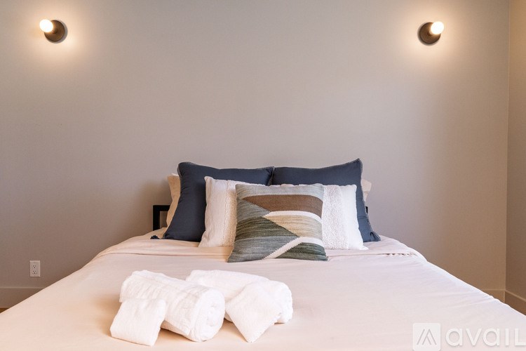 A bed with white towels on top of it.