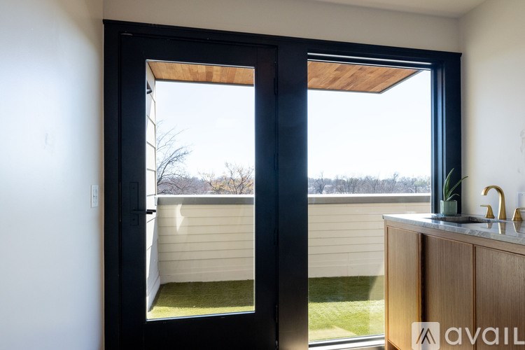 A modern house with a sliding door leading to a backyard.