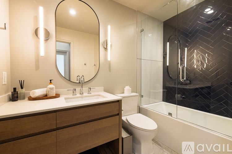 A bathroom with a sink, mirror, and toilet.
