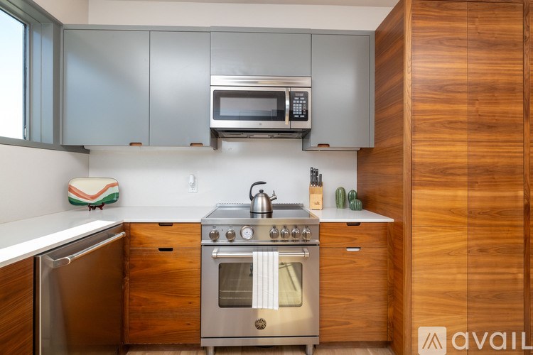 A kitchen with a stainless steel oven and microwave above a stove.