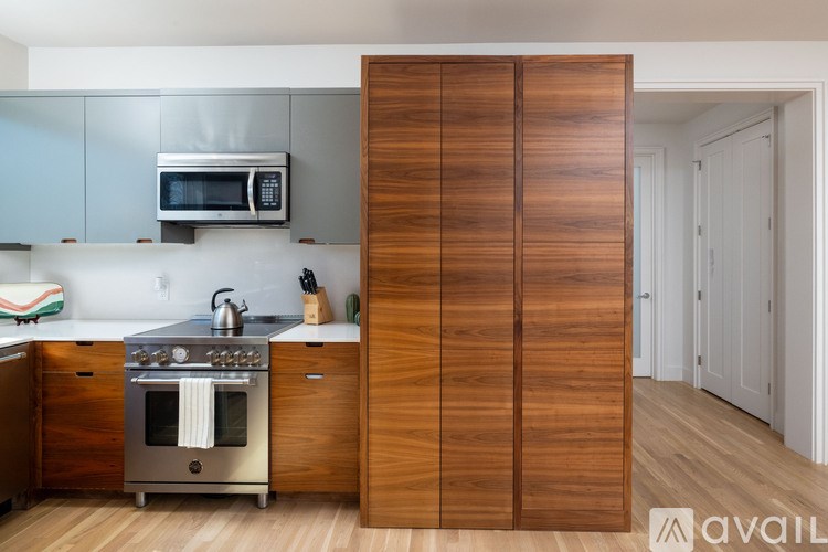 A kitchen with a stove top oven and microwave above it.