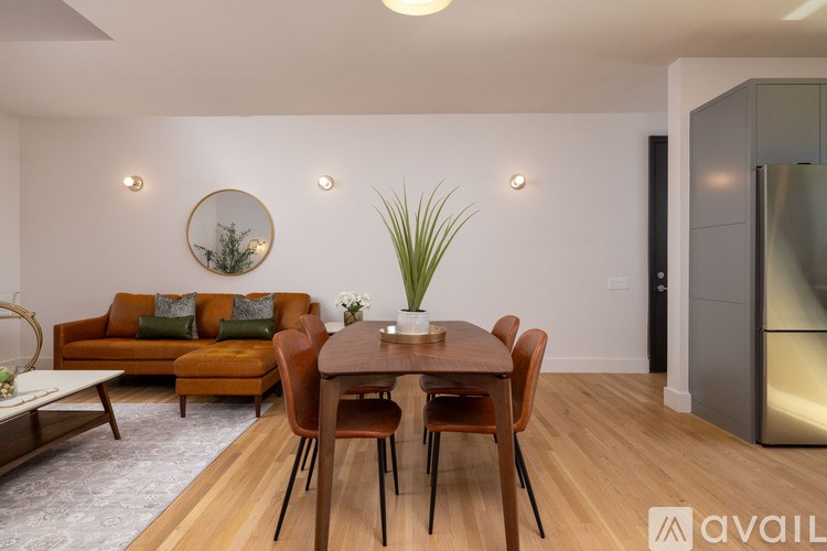 A modern dining room with a wooden table and chairs.