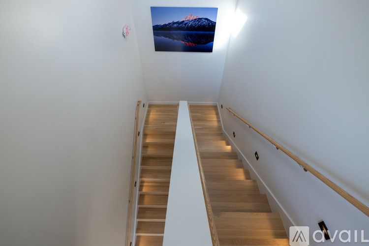 A staircase with wooden steps and a metal railing.