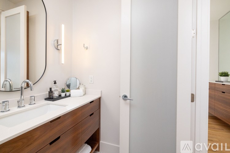 A bathroom with a white sink and a mirror above it.