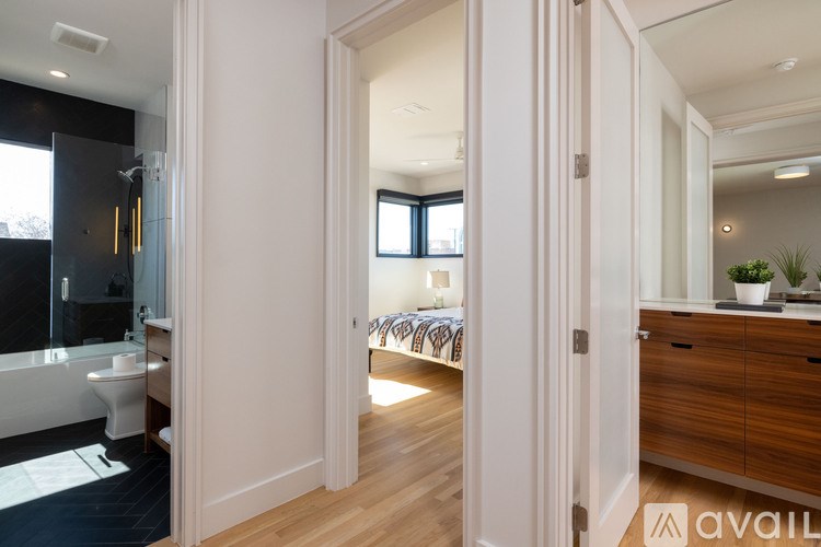 A bathroom with a tub and a mirror.