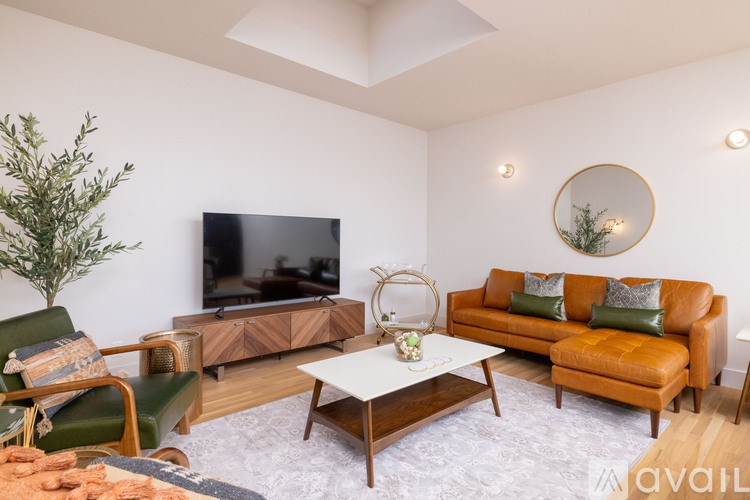 A living room with a television, two couches, and a coffee table.