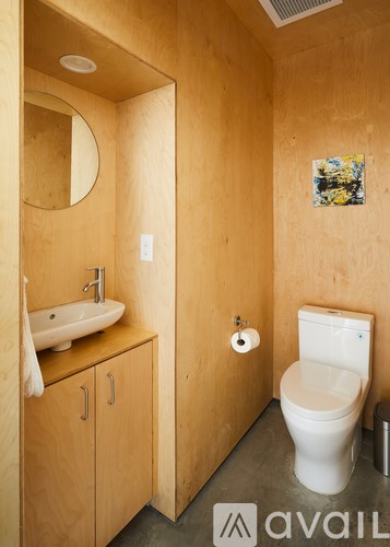 A bathroom with a toilet, sink, and mirror.