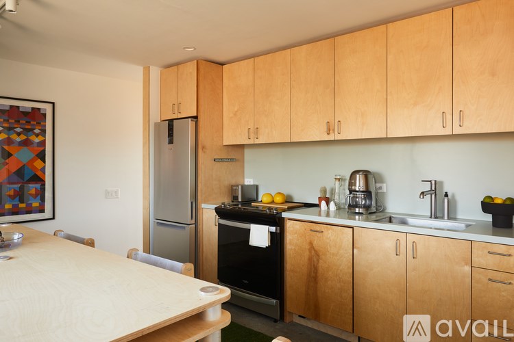 A kitchen with wooden cabinets and a fridge.