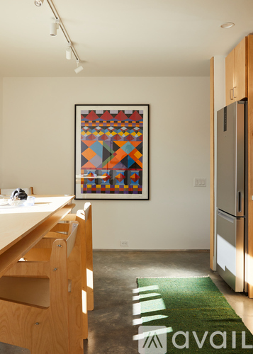 A kitchen with a framed picture on the wall.