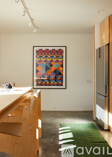 A kitchen with a framed picture on the wall.