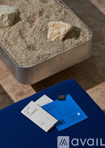 A blue book with a white tag on it is on a blue surface.