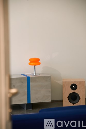 A small orange table with a speaker on the side.