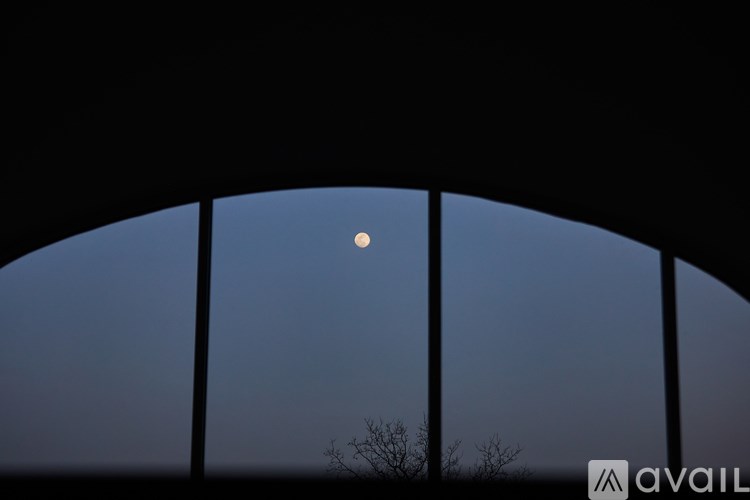 A moon is seen through a circular opening.