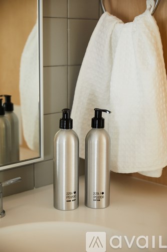 Two bottles of shampoo and conditioner are on a bathroom counter.