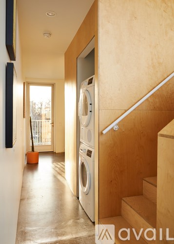 A washing machine is in a small laundry room.